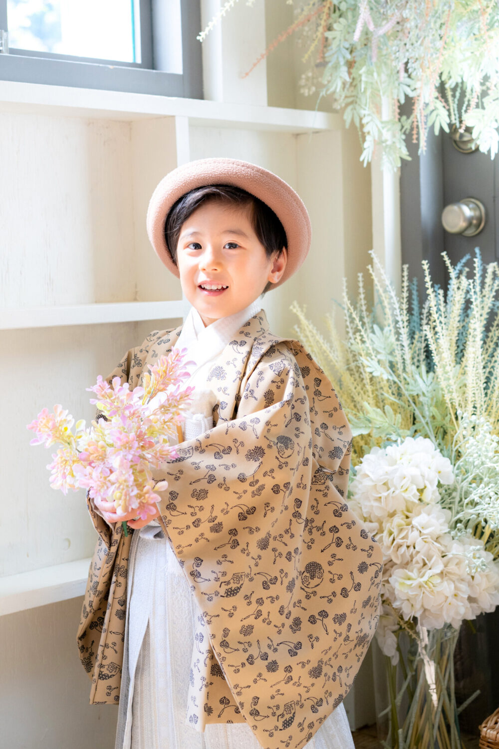 花を持って笑う5才の七五三の男の子